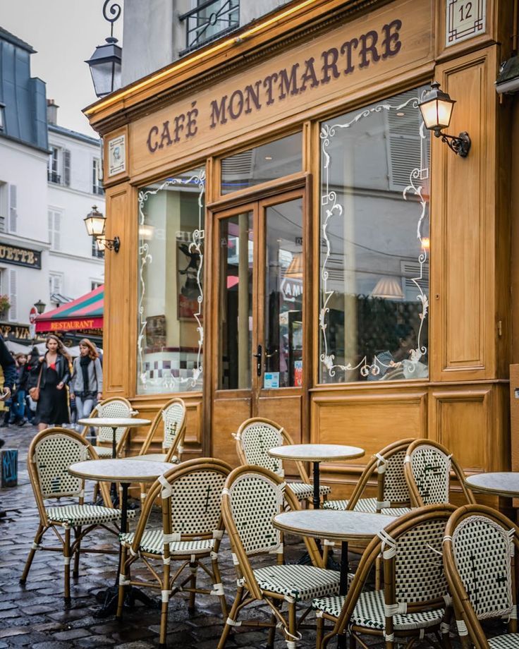 an outdoor cafe with tables and chairs outside