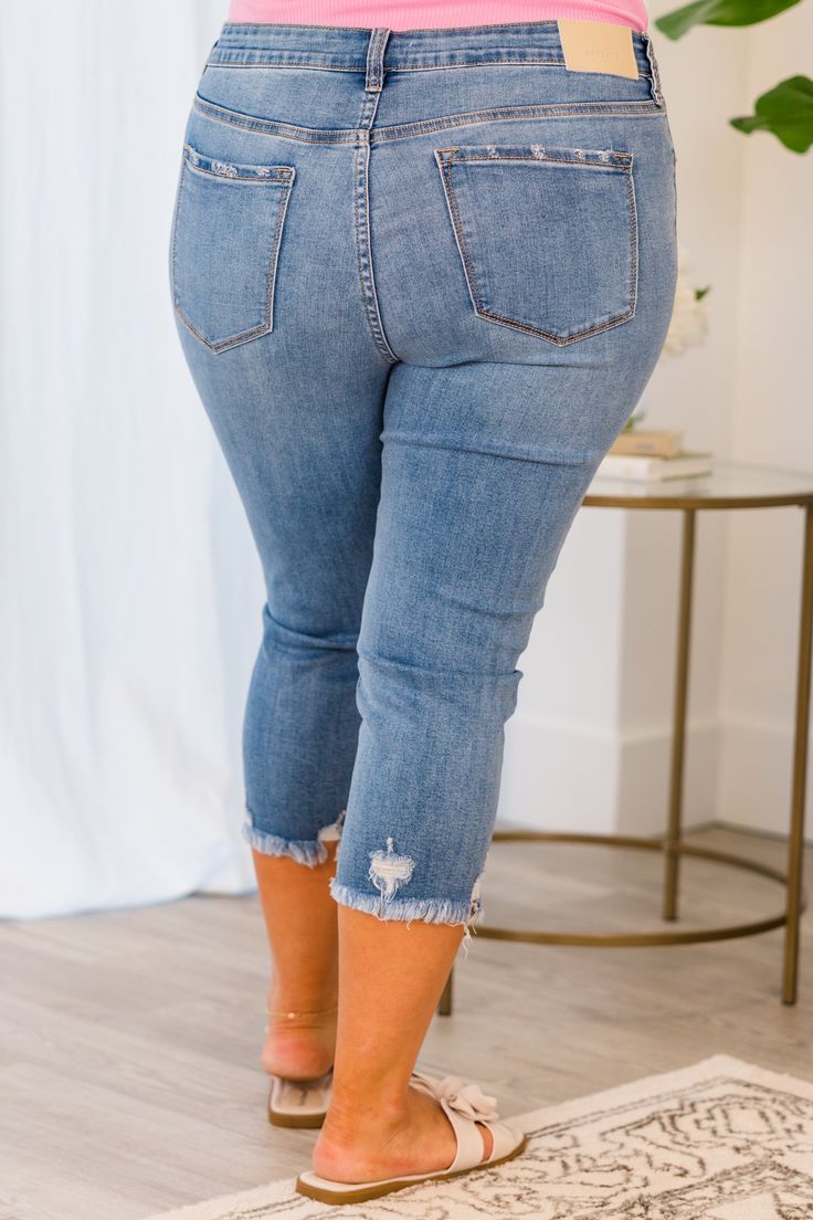 Get ready to turn heads with our Try Harder Capris in blue! These capris feature a button fly and distressed hem, adding a unique touch to your look. So go ahead, and stand out in style! 70% Cotton, 19% Polyester, 9% Rayon, 2% Spandex Spring Cropped Jeans In Denim Blue With Frayed Hem, Ripped Medium Wash Cropped Jeans, Medium Wash Ripped Cropped Jeans, Spring Ripped Cropped Jeans, Blue Cropped Jeans With Frayed Hem For Spring, Blue Cropped Jeans With Frayed Hem For Fall, Spring Cropped Leg Ripped Jeans, Fall Blue Cropped Jeans With Frayed Hem, Spring Cropped Ripped Jeans