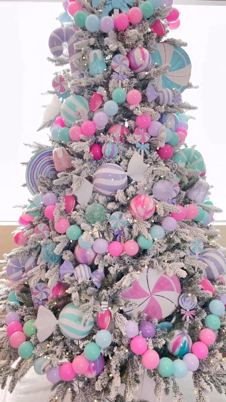 a white christmas tree decorated with colorful ornaments