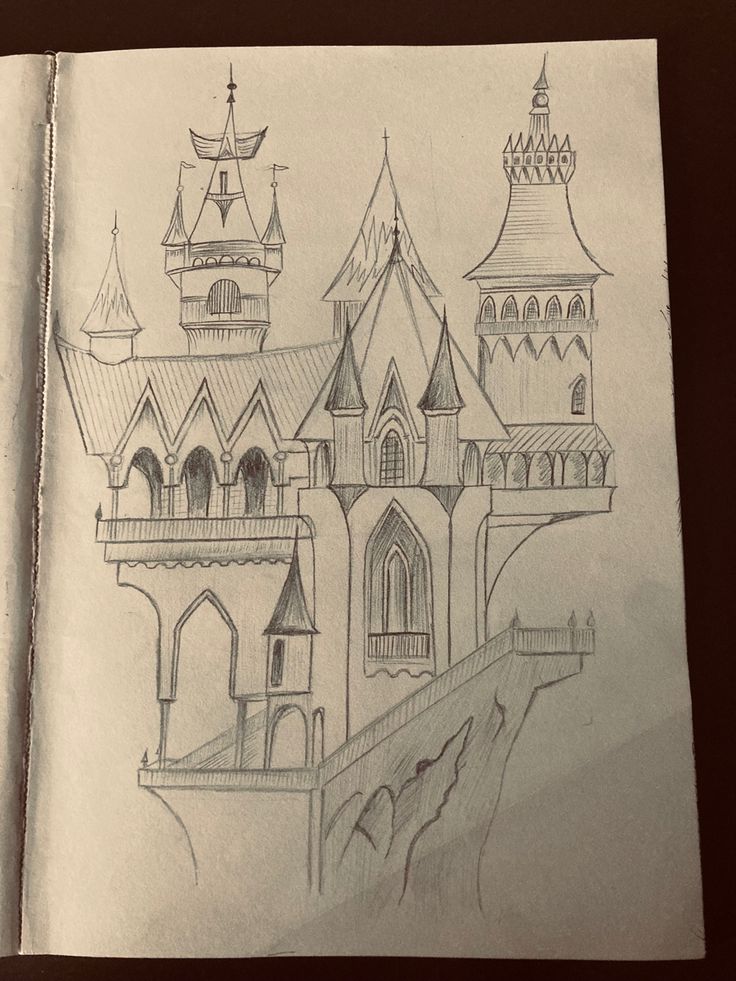 an open book with a drawing of a castle on it