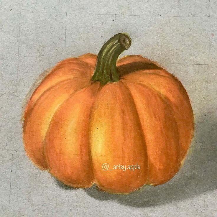 an orange pumpkin sitting on top of a white surface