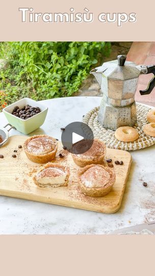 there is a wooden cutting board with pastries on it