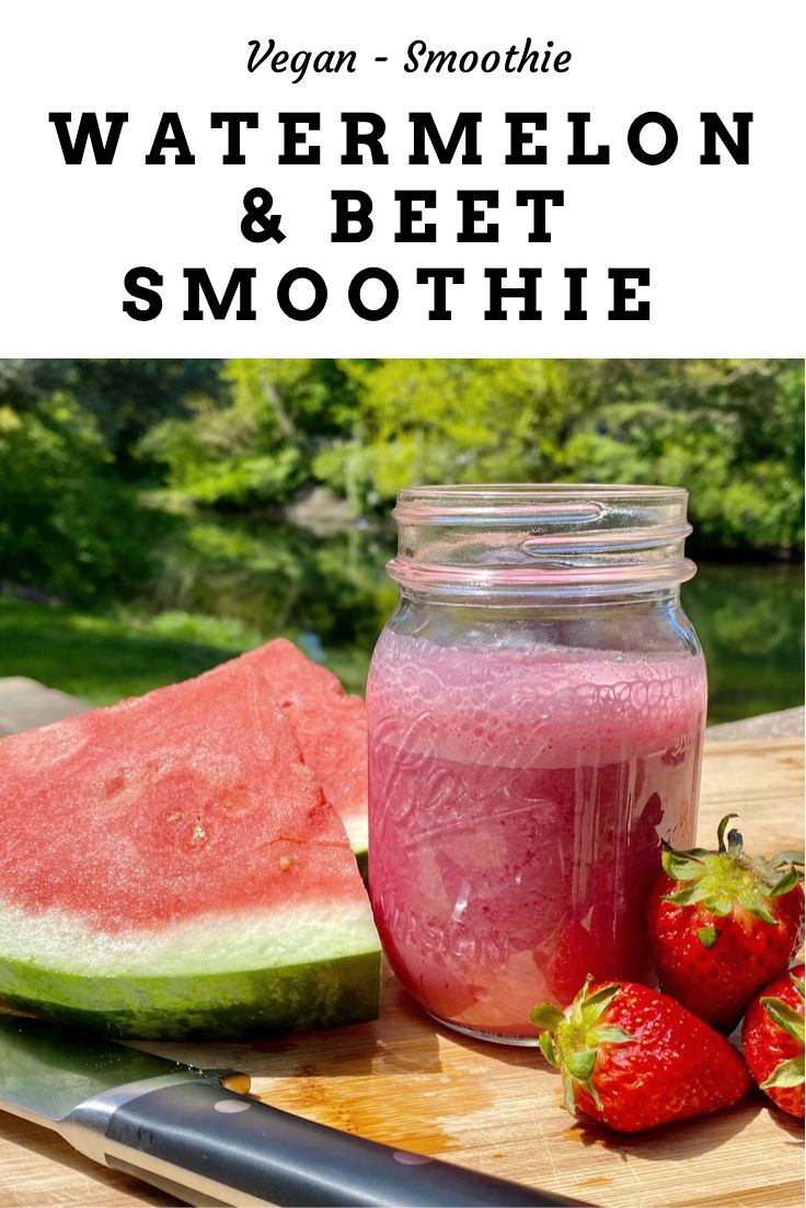 watermelon and beet smoothie in a mason jar with strawberries next to it