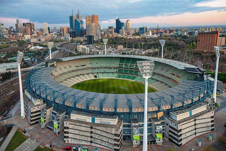 an aerial view of a stadium with the city in the background