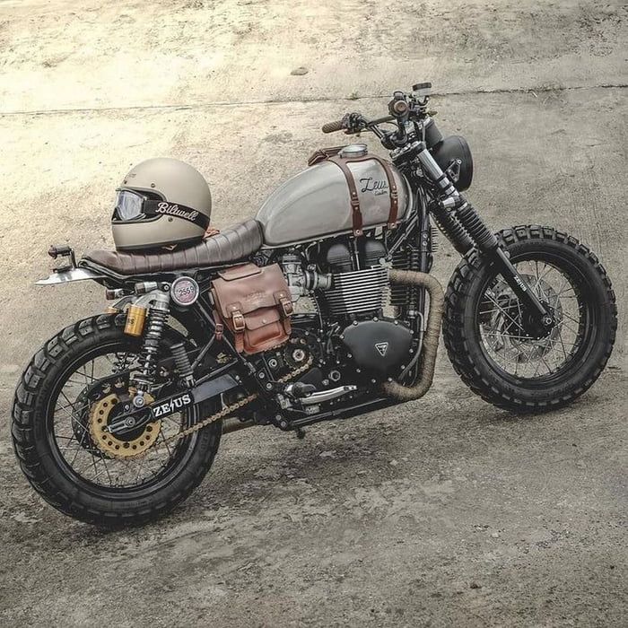 a motorcycle parked on top of a dirt field