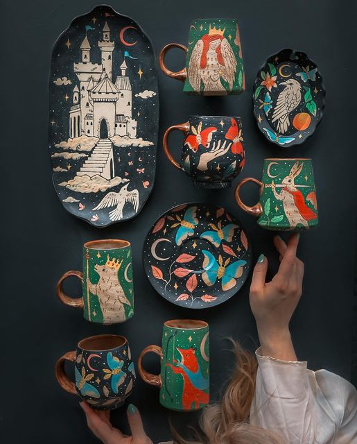 a woman is looking at an assortment of hand painted dishes and mugs on display