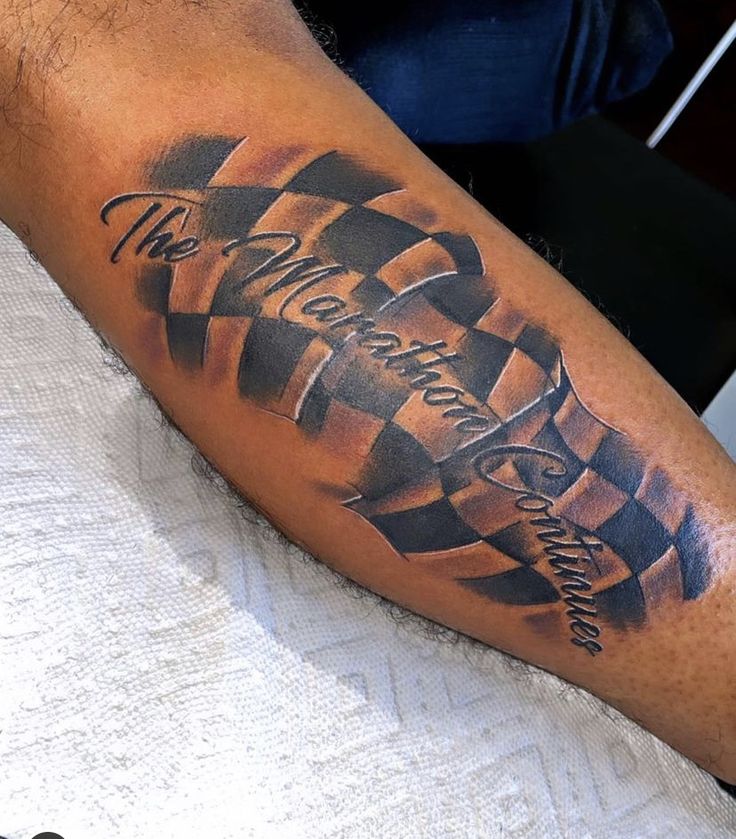 a man with a checkered tattoo on his arm