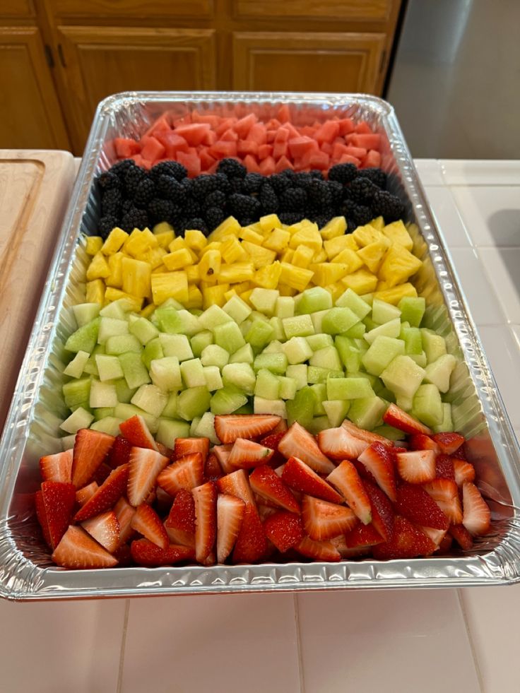 a tray filled with sliced fruit on top of a counter