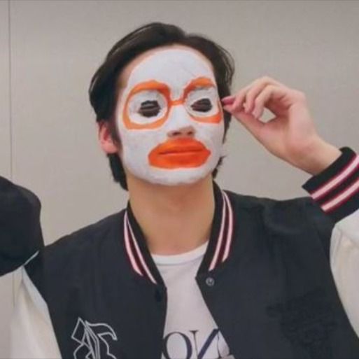 a man with his face painted orange and white