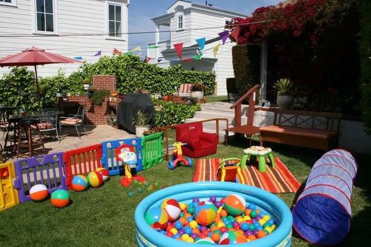 an inflatable pool with toys on the lawn