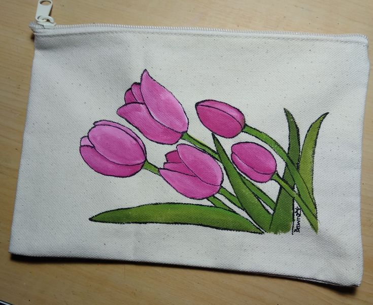 a white bag with pink tulips painted on it