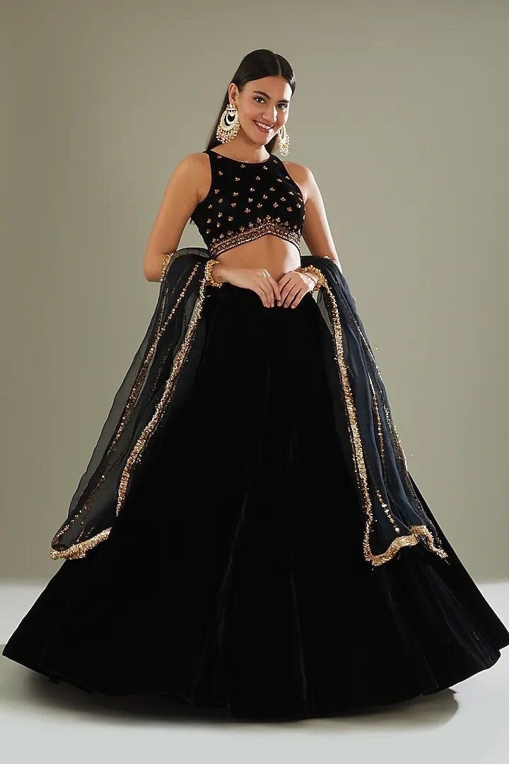 Black Velvet Lehenga Set Featuring a black lehenga in velvet base. It is paired with a matching blouse having nakshi and sequin work, including an organza dupatta. This product will be shipped to you after 1-2 weeks from the date of order placed. All custom made orders are not returnable. Pls contact for Size chart and for other more colors Request You :To provide contact details for courier services. {VARIATION MAY COME DEPENDING UPON AVALIBILITY OF LACES OR GOTTA PATI} NOTE:  1) Visual Samples on website may differ slightly from actual product due to light & effects during photography (Length & Breadth have 1 n 1.5 inches  +/-). 2) Before placing order ,pls confirm product n color availability on +91 7903893945 & +91 8447750028(WhatsApp) 3) For Wholesale Order MOQ is 5 Pieces of any colo Velvet Blouse For Lehenga, Black Velvet Lehenga, Blouse For Lehenga, Ruffled Saree, Black Velvet Blouse, Berry Dress, Velvet Lehenga, Black Lehenga, Independance Day