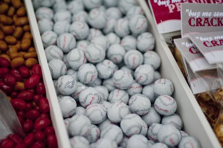 several boxes filled with baseballs and nuts