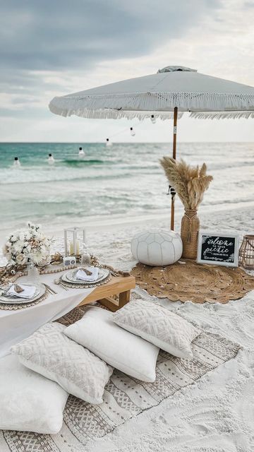 a table set up on the beach for an outdoor dinner