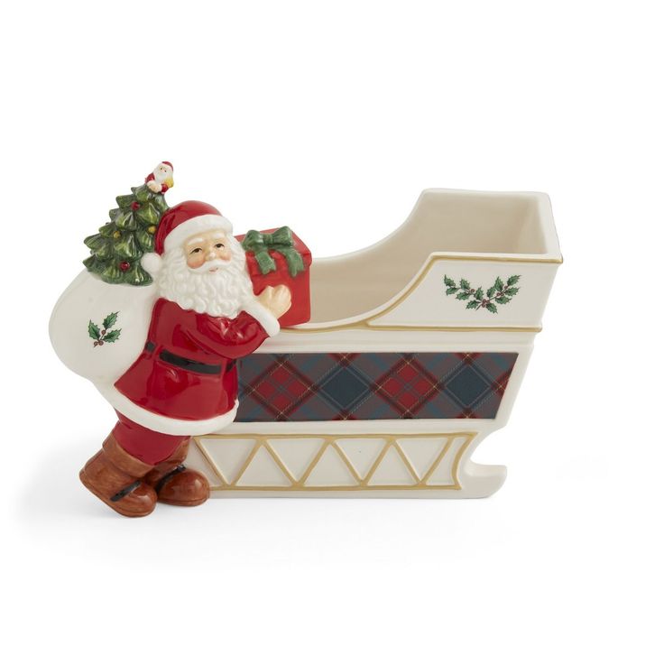 a santa clause figurine sitting on top of a sleigh