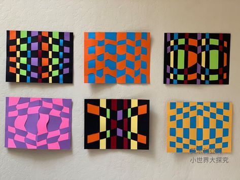 four different colored squares are hanging on the wall