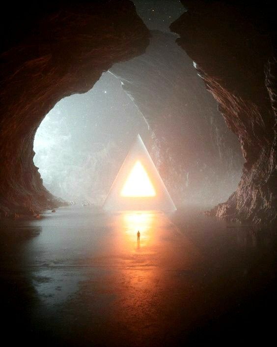 a man standing in the middle of a cave with a triangle shaped light at the end