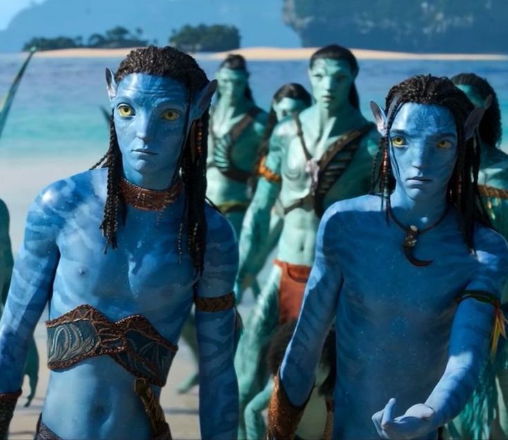 the blue man group from avatar is standing in front of an ocean with other people