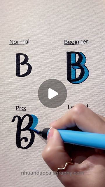 a person is writing on a piece of paper with blue marker and black letters that spell out the letter b