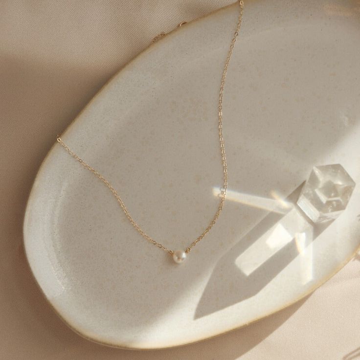 The epitome of classic, the Margot necklace (French for pearl) is a timeless piece to wear on special occasions or for an everyday polished look. Each purchase comes with an elegant, vegan leather box for storing + caring for your jewelry. DETAILS14k Solid Gold | Pearl measures 1/2 mmAvailable in 14", 16" or 18" Classic Single Strand Pearl Necklace In 14k Gold, Timeless 14k Gold Necklace With Pearl Chain, Classic 14k Gold Pearl Necklace, Classic Akoya Pearl Necklace With Delicate Chain, Timeless Everyday Pearl Necklaces, Classic 14k Gold Pearl Chain Necklace, Classic Round 14k Gold Pearl Necklace, Classic 14k Yellow Gold Pearl Necklace, Classic Everyday Necklace With Pearl Charm