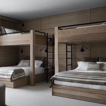 a bedroom with two bunk beds and a couch in the corner next to each other