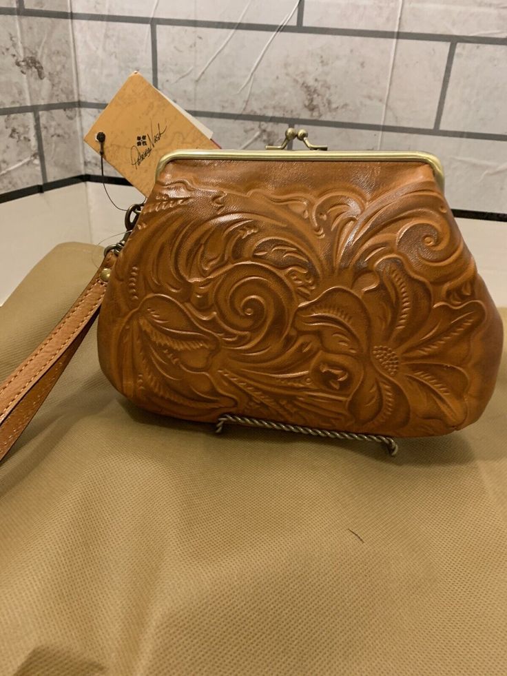 PATRICIA NASH TOOLED LEATHER WRISTLET NEW WITH TAG. Condition is New with tags. Shipped with USPS First Class. Leather Wristlet For Daily Use, Leather Bag With Wrist Strap For Gift, Leather Wallet With Wrist Strap, Leather Handheld Wristlet For Everyday Use, Elegant Brown Leather Wristlet, Elegant Leather Clutch With Hand Tooled Details, Everyday Hand-tooled Leather Clutch, Brown Leather Clutch With Snap Closure, Hand Tooled Leather Pouch Wallet