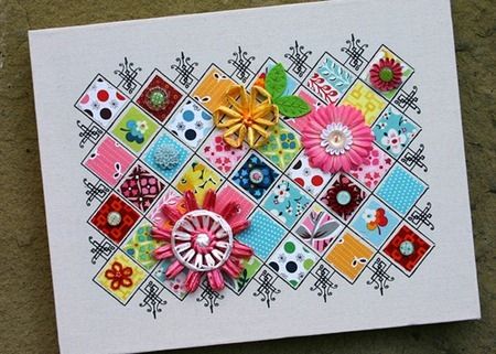 a white card with colorful flowers on it sitting on top of a stone floor next to a brick wall