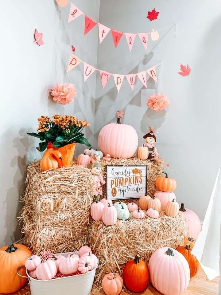 pumpkins and hay bales are arranged in front of a sign that says happy thanksgiving