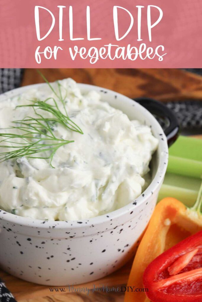 dill dip for vegetables in a white bowl with tomatoes and celery on the side