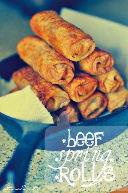 some food that is in a bowl on a table with the words beef spring rolls