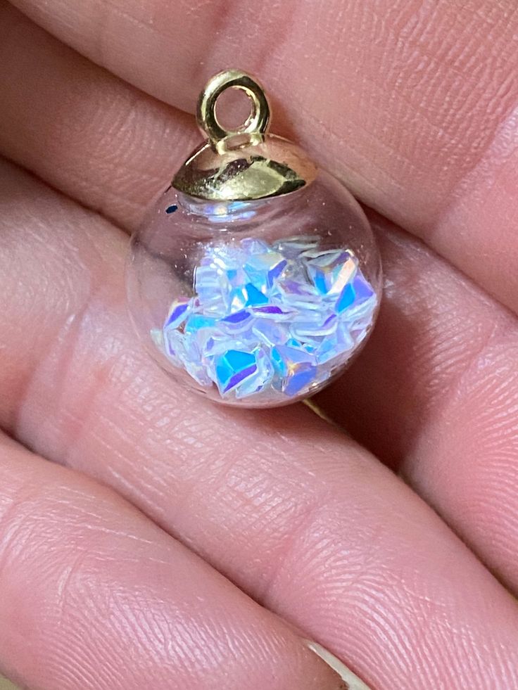 Cute clear glass globes with opal triangle confetti inside! Top is gold plate with loop. These would be cute as little girl jewelry! Loop is large enough to use a ribbon or cord! More colors of glass ball charms in shop! ball measures 16mm, loop ID 2mm spiritualnaturegifts.etsy.com New listings added daily! Be sure to favorite my shop! Thanks for looking! Cute Round Jewelry For Party, Cute Iridescent Jewelry For Gift, Cute Clear Party Jewelry, Cute Clear Jewelry For Party, Sparkling Round Beads Jewelry For Gift, Gift Sparkling Jewelry With Round Beads, Nickel Free Clear Jewelry For Party, Nickel-free Clear Jewelry For Parties, Magical Gold Jewelry For Party