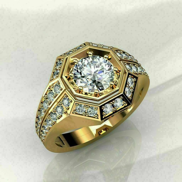 a yellow gold ring with diamonds on the sides and a center stone in the middle