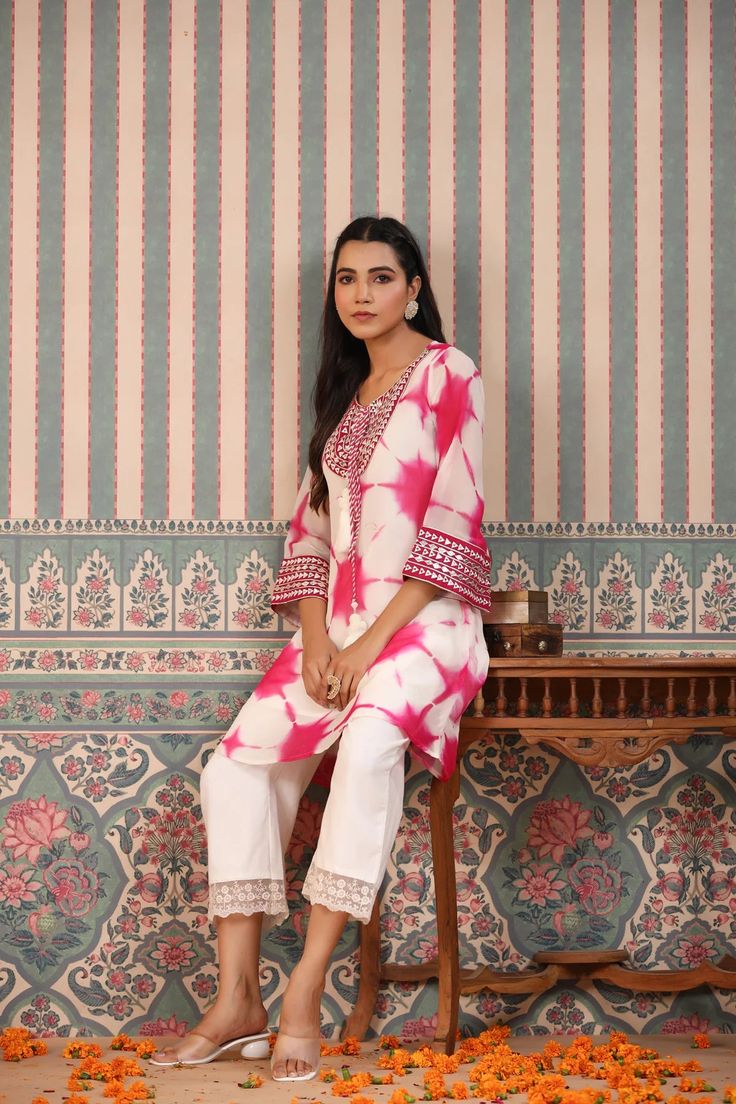 Indulge in elegance with our Pink Tie And Dye Suit Set. The beautiful pink hue and handwork make it the perfect statement piece for any occasion. Crafted from luxurious organza, the delicate tassels add a touch of charm to this unique and sophisticated ensemble. Elevate your wardrobe with this exclusive piece. No. of pieces - 2 piece set. Color - Pink. Kurta Fabric - Organza. Washing Instructions - Dry Clean. Pink Organza Salwar Kameez With Sheer Dupatta, Pink Organza Set With Dupatta, Elegant Embroidered Pink Kurta, Pink Organza Salwar Kameez For Wedding, Elegant Pink Sets With Gota Work, Pink Silk Kurta For Party, Pink Unstitched Organza Kurta, Pink Organza Kurta With Sheer Dupatta, Pink Silk Traditional Set