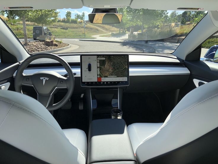 the interior of a car with a gps device in the front seat and an ipad on the dashboard