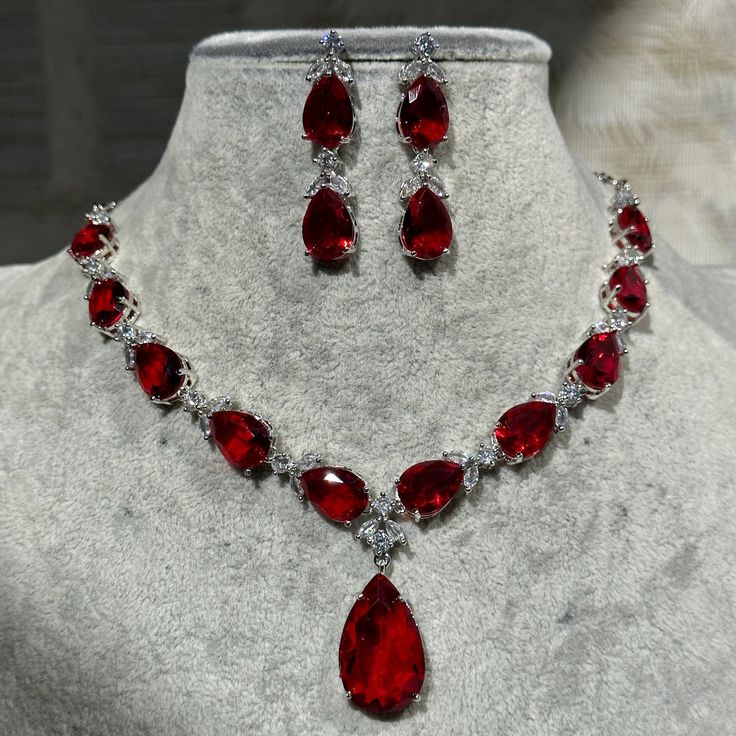 Handmade  Style: Necklace and Earrings Set Material: Platinum Plated, Lab Simulated Ruby and White Sapphire Stones Imported Size: Earrings measure 1.60 inches long. Please Note: This necklace and earrings are sold as a set. Item Number: 7074R Red Diamond Jewelry Set, Red Prom Necklace, Red Jewel Necklace, Red Diamond Jewelry, Red Jewelry Necklace, Ruby Jewelry Set, Red Ruby Necklace, Necklace Stacks, Ruby Red Necklace