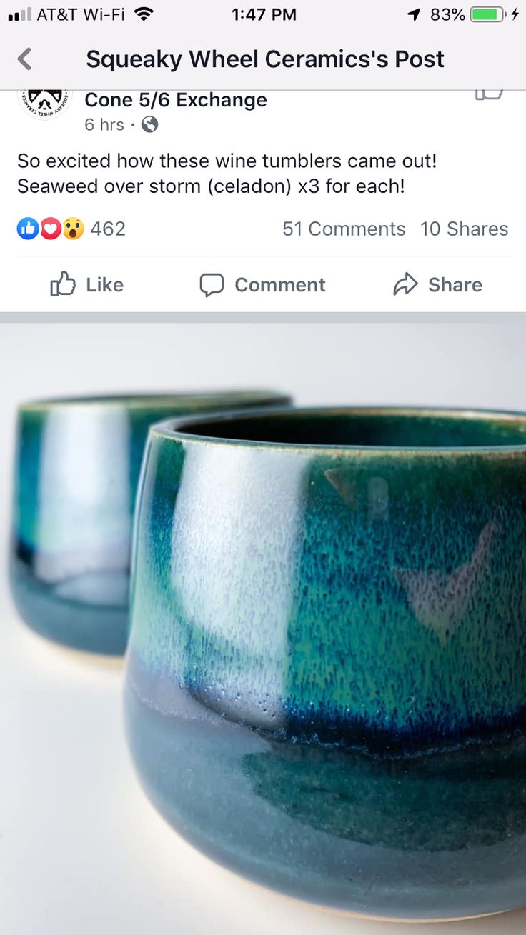 two ceramic bowls sitting on top of a table next to each other, one blue and the other green