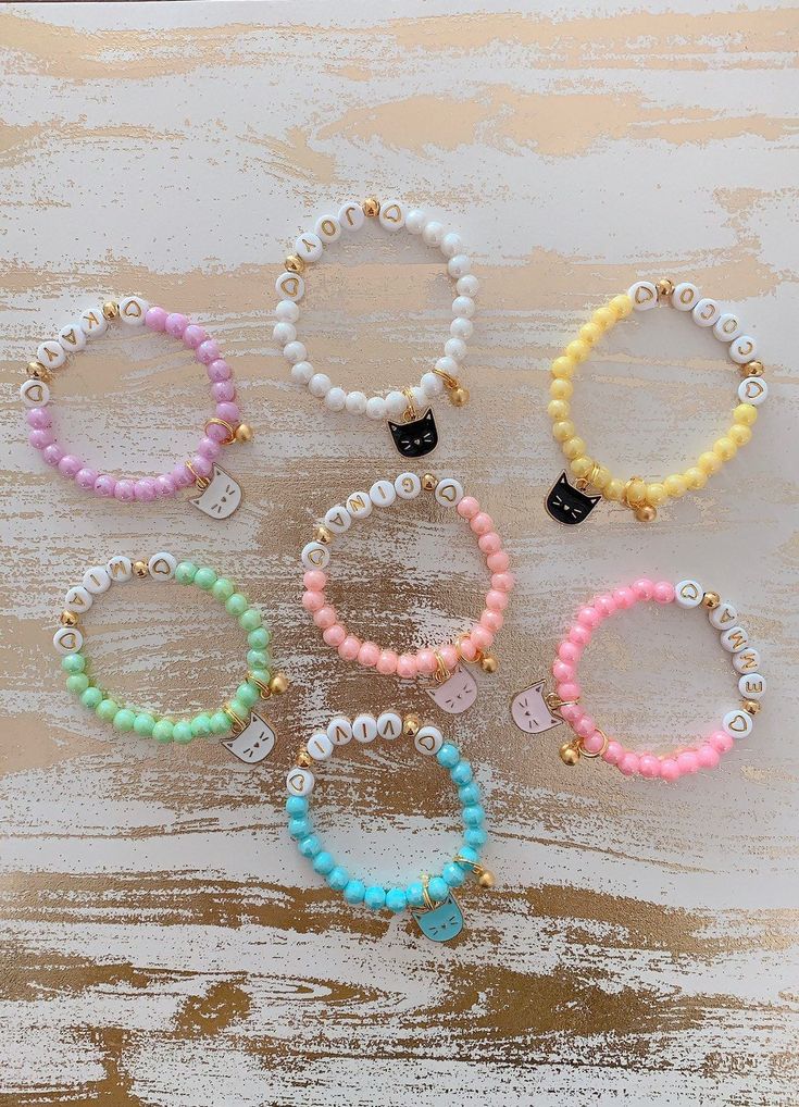 "Adorable 🐱kitty charm bracelets for all your cat lovers!! Bracelet is perfect for anyone any occasion! All orders come with 1 custom name beaded bracelet mixed with 24K gold bell charm and a kitty charm of your choice! You will have 7 colored beads and 4 different colored kitty charm to choose from. How to order: 1. Please select the bracelet size from the first drop down 2. Please select the bead color of your choise 3. In the personalization box - please enter the name you would like to plac Cute Charm Bracelets For Friendship, Cute Name Bracelet With Round Beads For Everyday, Cute Everyday Name Bracelet With Round Beads, Cute Hypoallergenic Charm Bracelet For Friendship, Cute Beaded Bracelets With Charms For Gift, Cute Friendship Bracelets With Charms, Playful White Bracelet With Charms, Playful White Charm Bracelet, Kawaii Hypoallergenic Jewelry For Birthday