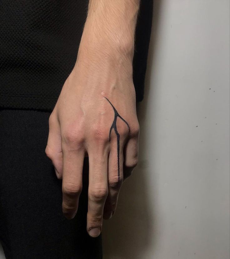 a person with a tattoo on their left hand