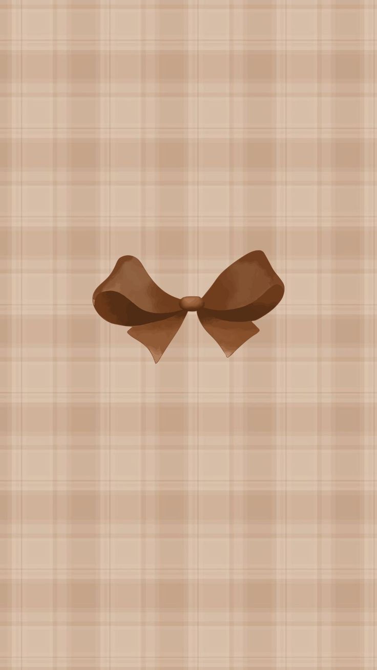 a brown bow on a tan plaid background