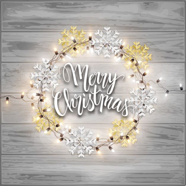 merry christmas wreath with lights on wooden background