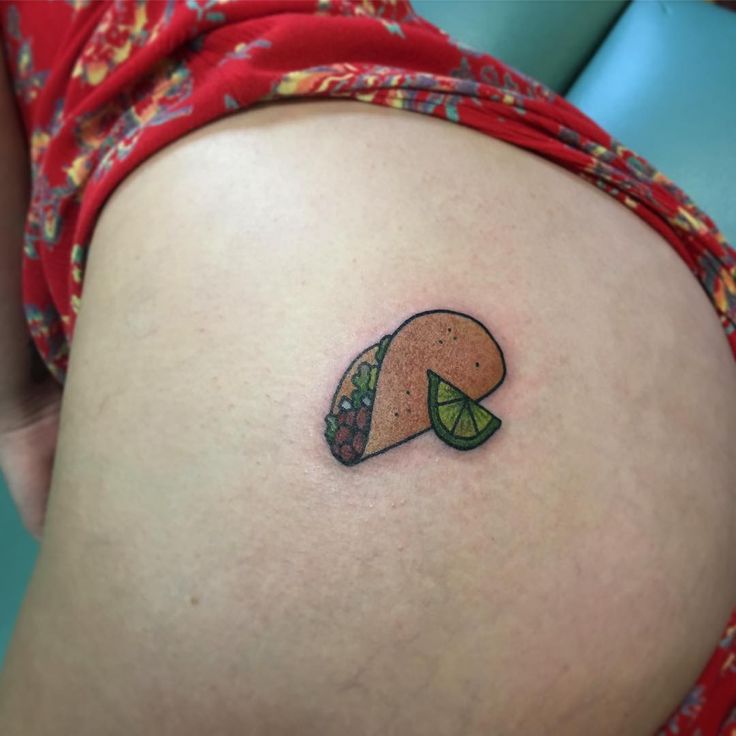 a small taco tattoo on the back of a woman's thigh and leg