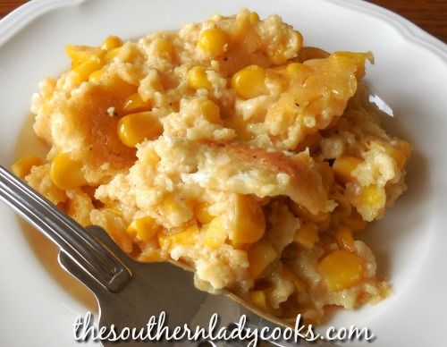 a white plate topped with mashed potatoes and corn