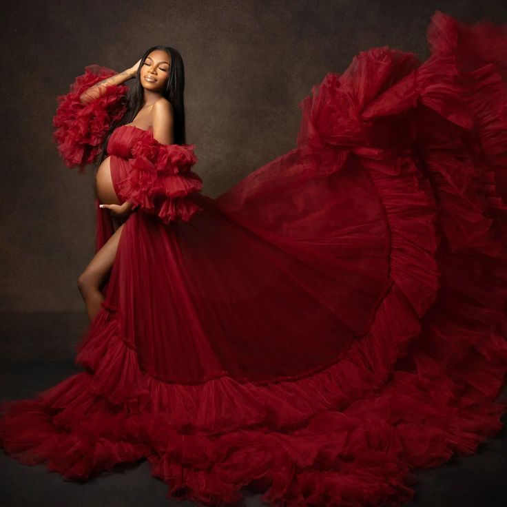 a woman in a red dress posing for the camera