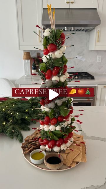 a christmas tree made out of crackers and tomatoes on top of a white table