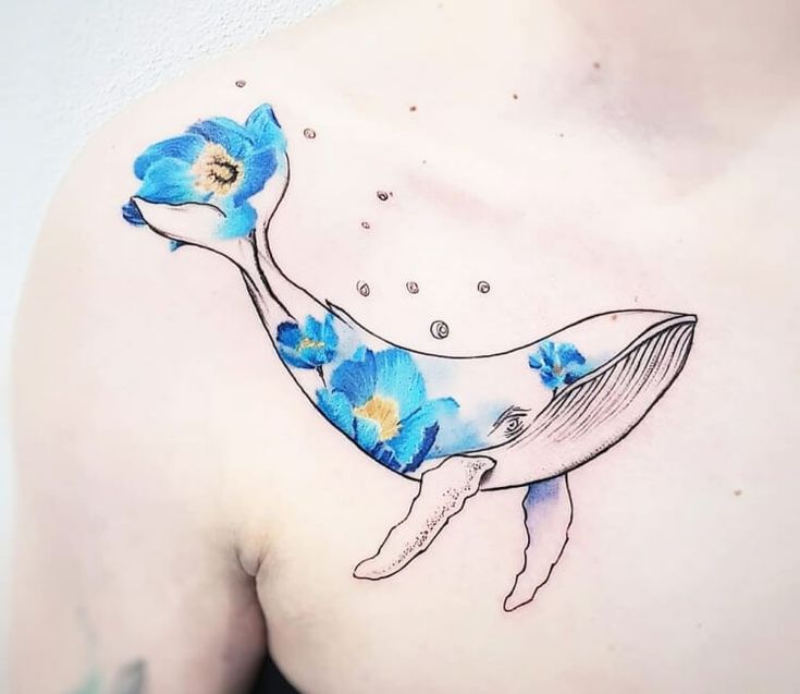 a blue whale with flowers on it's chest and under the water droplets tattoo