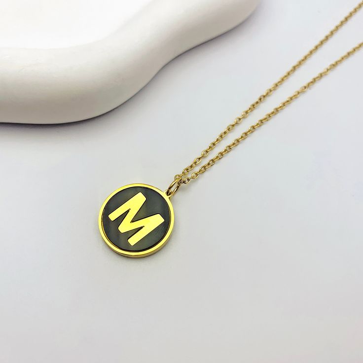 For the modern minimalist, our Alphabet Letter Round Black Initial Charm Necklace is a must-have accessory! This sleek and stylish necklace is available in both gold and silver, featuring a cute black and gold initial charm that adds a personalized touch to any outfit. Choose your favorite letter or stack multiple necklaces for a trendy accessory that's perfect for expressing yourself in style. Available in gold and silver. Personalized Black Stainless Steel Necklaces, Black Personalized Initial Pendant Jewelry, Personalized Black Initial Pendant Jewelry, Trendy Personalized Black Necklace, Trendy Black Personalized Necklace, Elegant Black Necklace For Personalized Gift, Gold Minimalist Initial Necklace In Stainless Steel, Minimalist Gold Stainless Steel Initial Necklace, Minimalist Black Jewelry For Personalized Gifts