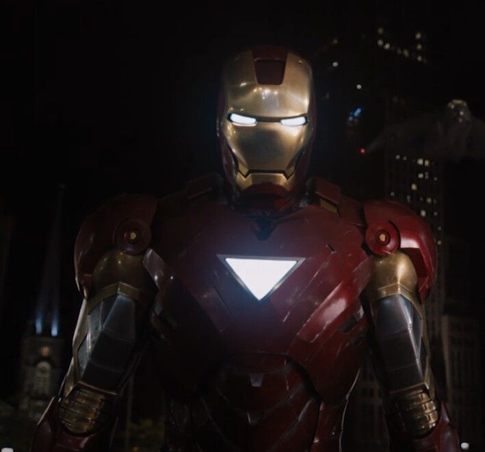 iron man standing in the city at night