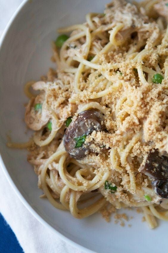 a white bowl filled with pasta and mushrooms