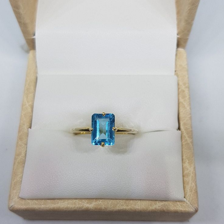 14k solid yellow gold natural emerald cut rectangular shaped blue topaz semi precious gemstone ring. 1. The weight of natural blue topaz gemstone used in the ring =1.40 cts. 2. The weight of 14k solid yellow gold used in the ring =1.150 grms. 3. The topaz is the birthstone for the people born in the month of November. 4. The design of the ring is very nice and beautiful. 5. I have used all my skills and experience to manufacture this ring as beautiful as I can and I do hope that my work will be Formal Topaz Ring With Rectangular Stone, Formal Rectangular Topaz Stone Ring, Modern Gold Topaz Ring In Rectangular Shape, Modern 14k Gold Emerald Cut Topaz Ring, Modern Gold Rectangular Topaz Ring, Fine Jewelry Topaz Ring With Rectangular Accent Stones, Classic Blue Topaz Ring With Rectangular Stone, Fine Jewelry Yellow Gold Octagon Topaz Ring, Yellow Gold Octagon Topaz Ring