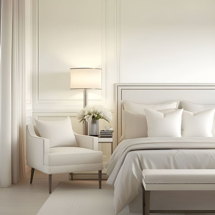 a bedroom with white furniture and pillows on the bed, along with a lamp in the corner